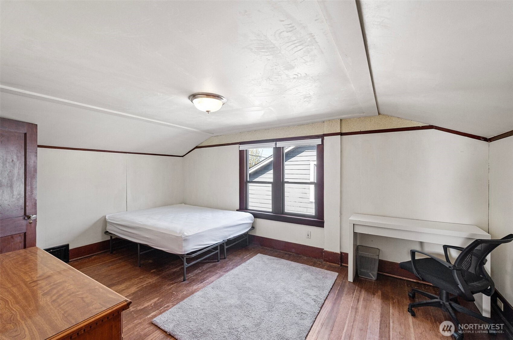 5016 7th Avenue Northeast Seattle, WA 98105 - Photo 14 of 36 a bedroom with a bed and wooden floor