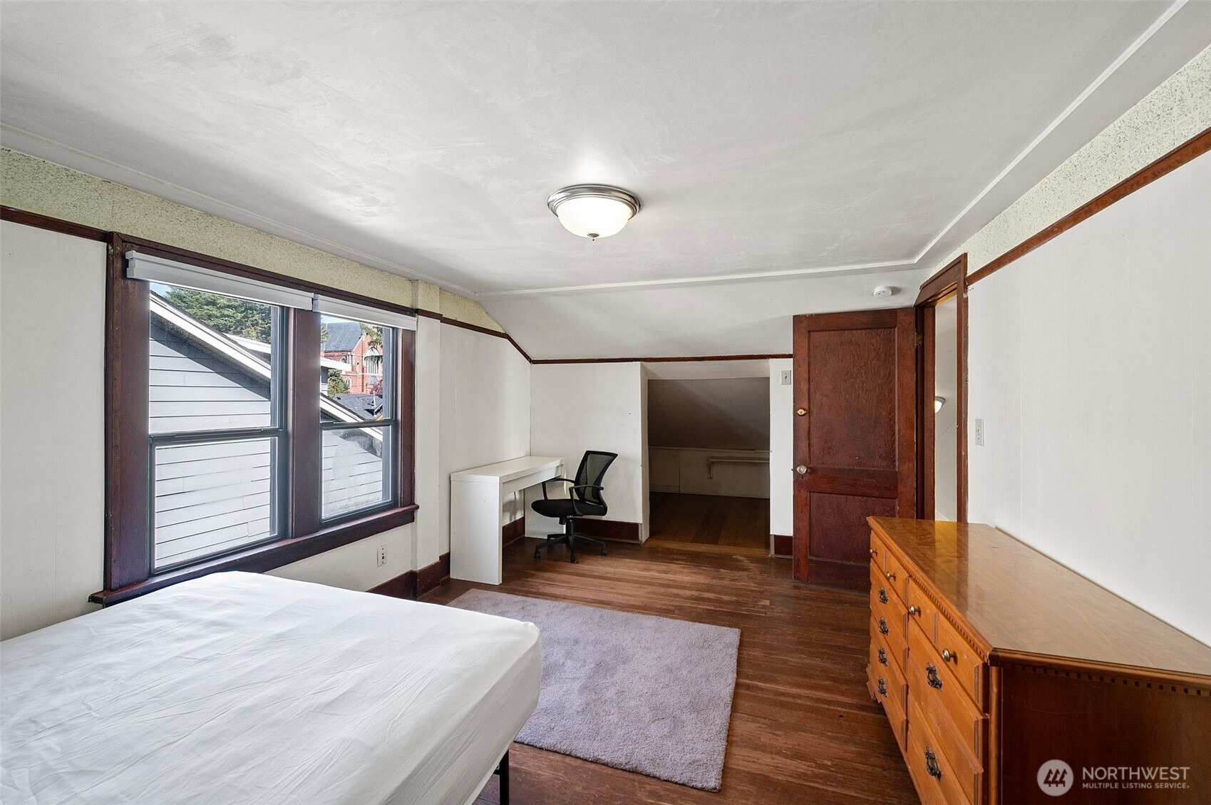 5016 7th Avenue Northeast Seattle, WA 98105 - Photo 15 of 36 a bedroom with a bed and wooden floor