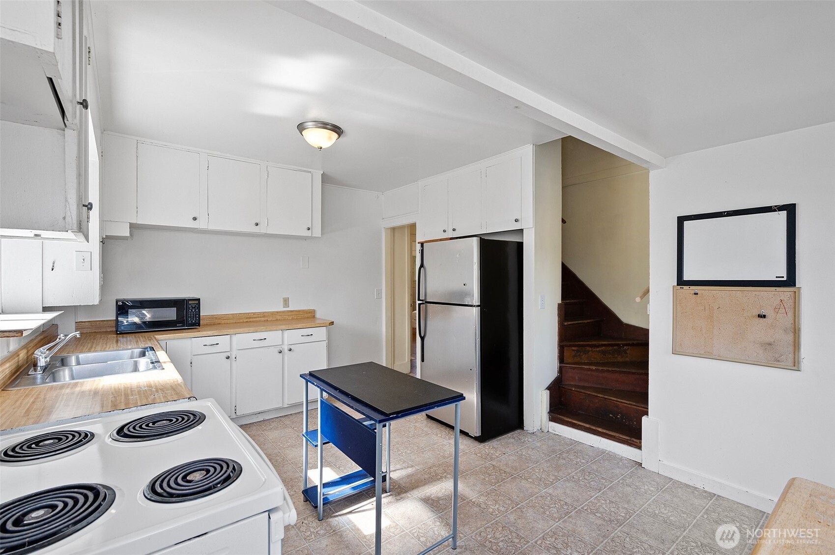 5016 7th Avenue Northeast Seattle, WA 98105 - Photo 16 of 36 a kitchen with a cabinets a stove a sink and a refrigerator