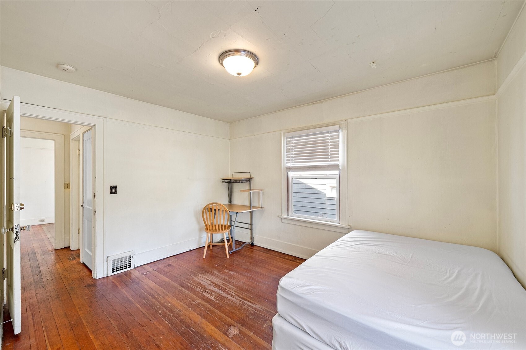 5016 7th Avenue Northeast Seattle, WA 98105 - Photo 22 of 36 a bedroom with a bed and chair
