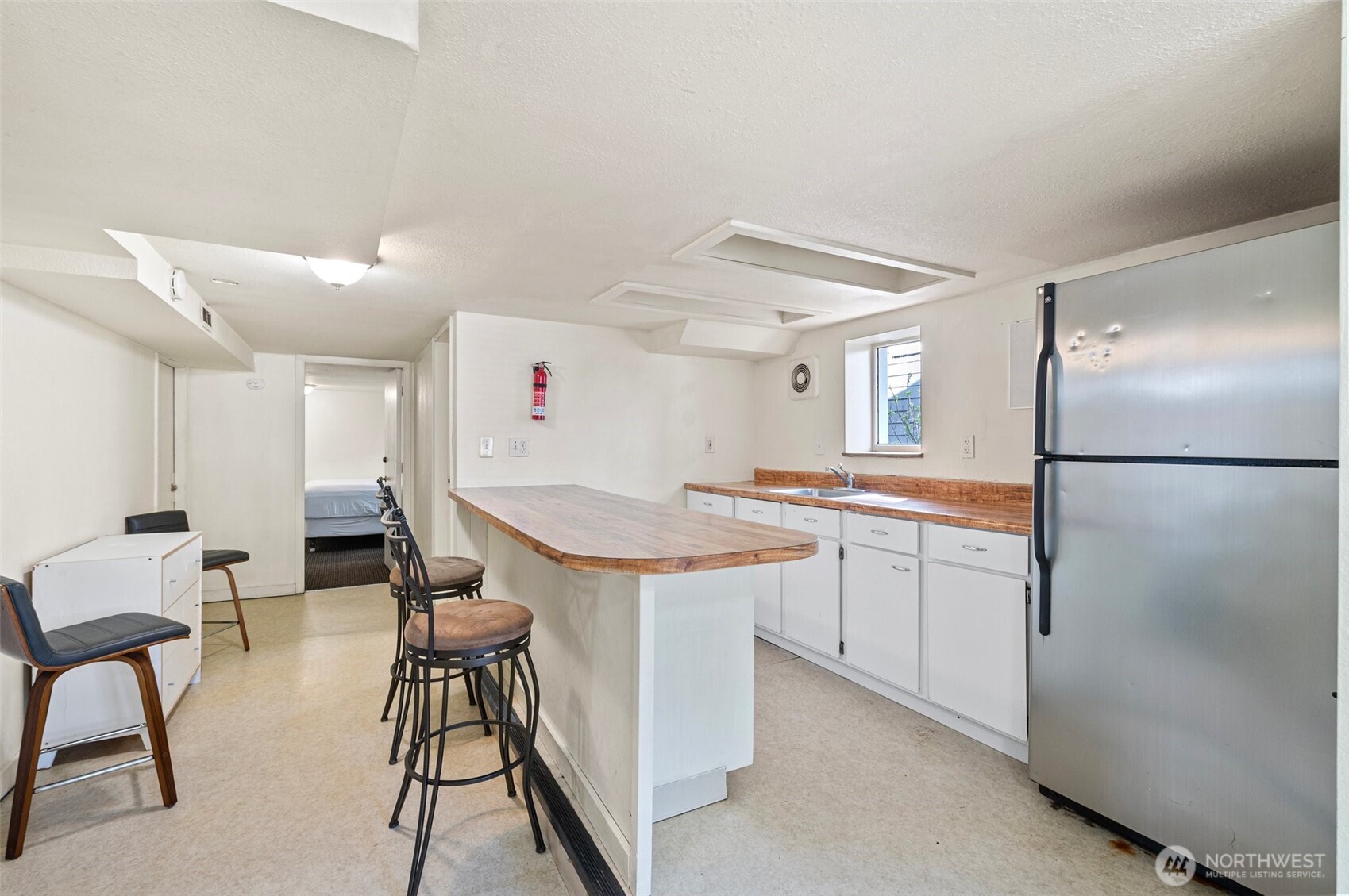5016 7th Avenue Northeast Seattle, WA 98105 - Photo 24 of 36 a room with furniture a refrigerator and a sink