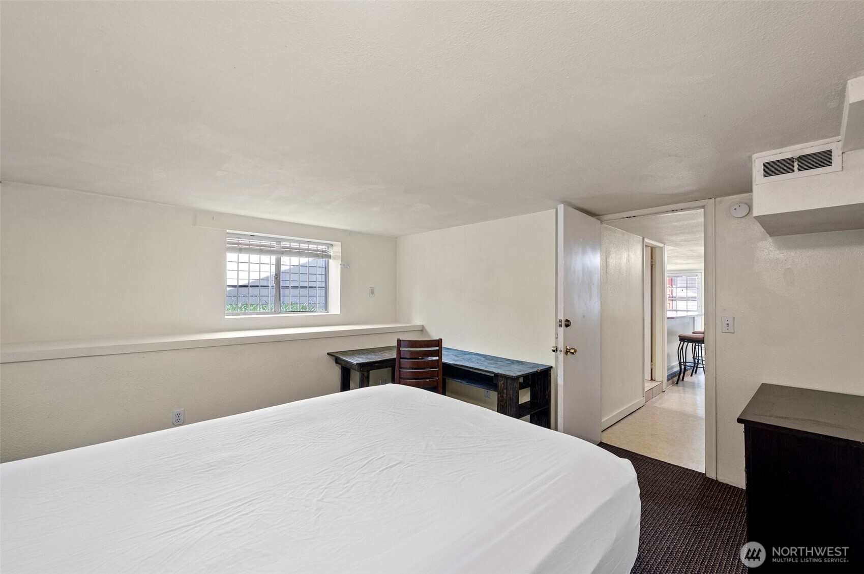5016 7th Avenue Northeast Seattle, WA 98105 - Photo 29 of 36 a bedroom with a bed and a table with chair