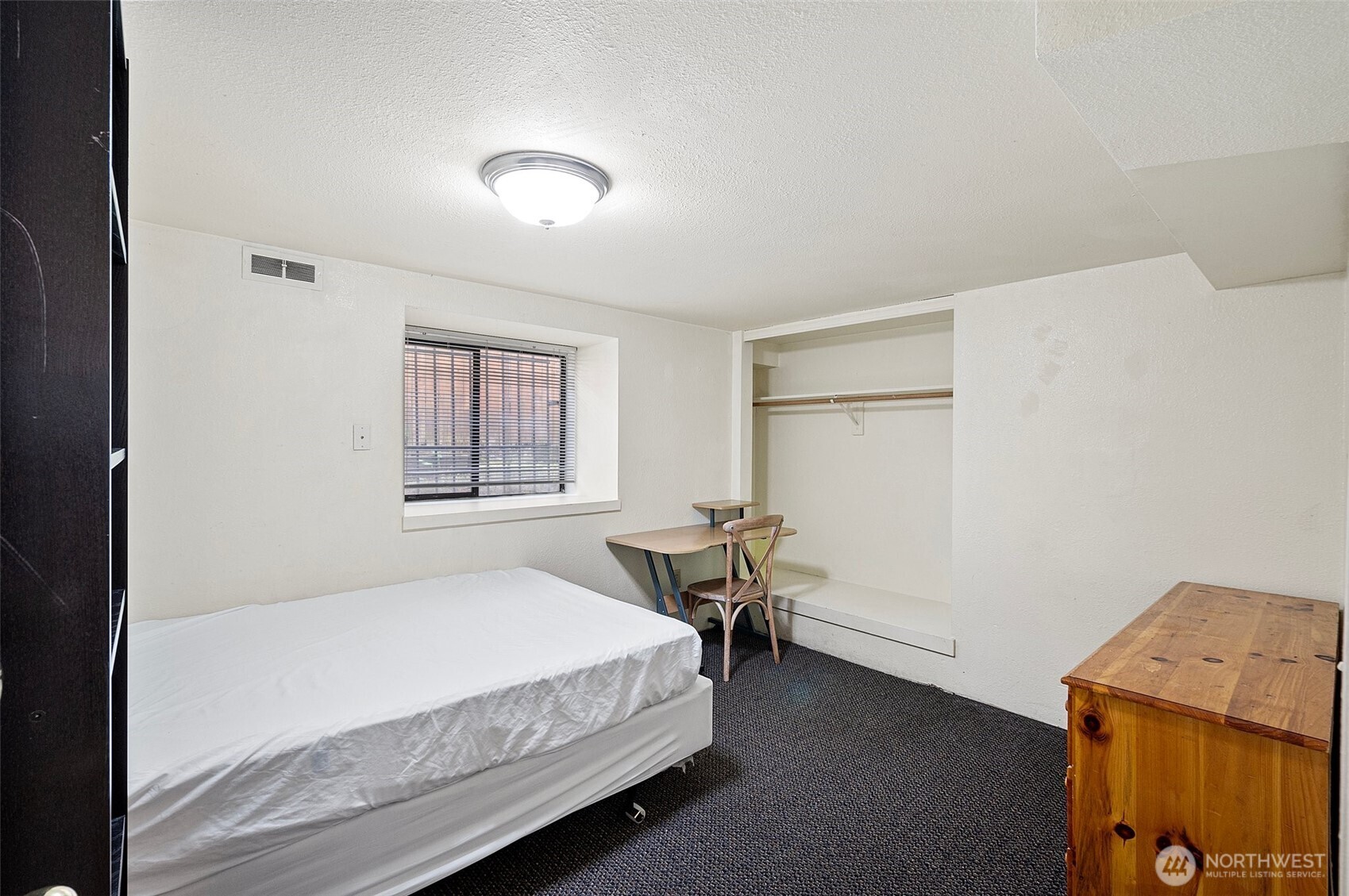 5016 7th Avenue Northeast Seattle, WA 98105 - Photo 31 of 36 a bedroom with a bed and a window