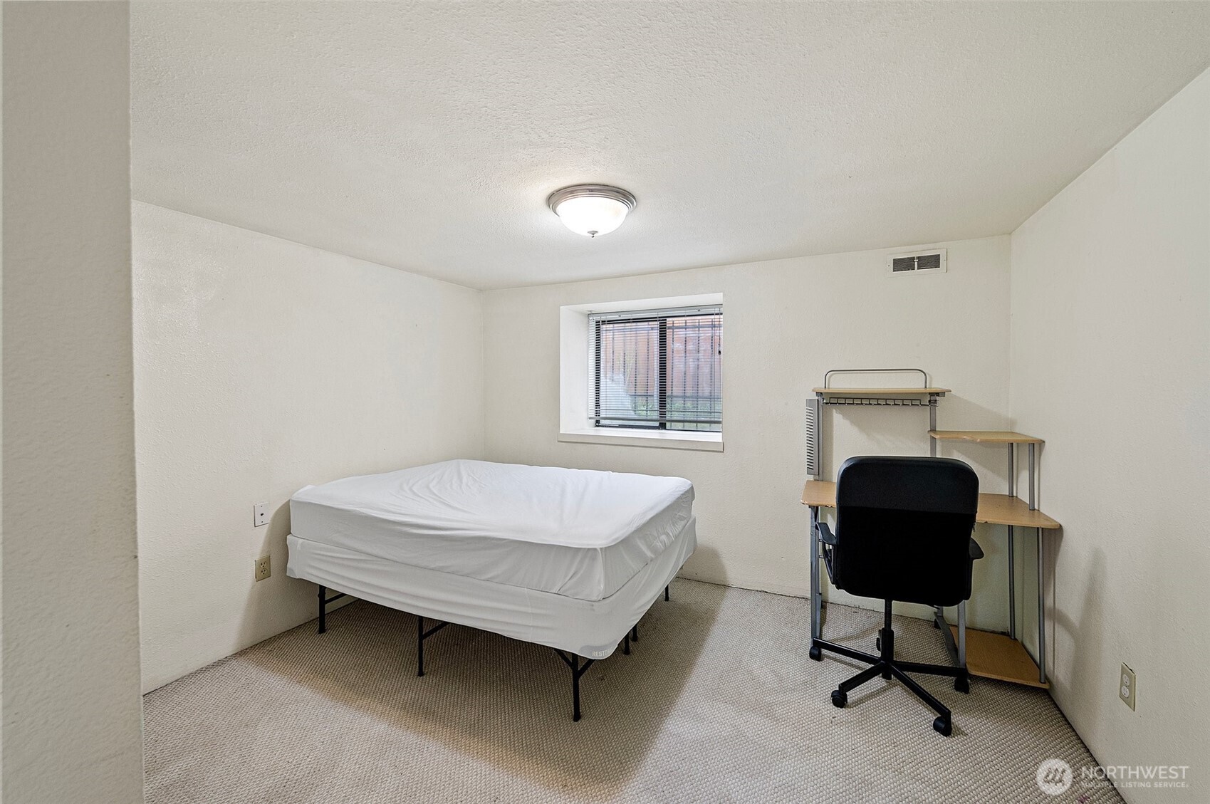 5016 7th Avenue Northeast Seattle, WA 98105 - Photo 32 of 36 a bedroom with a bed window and chair