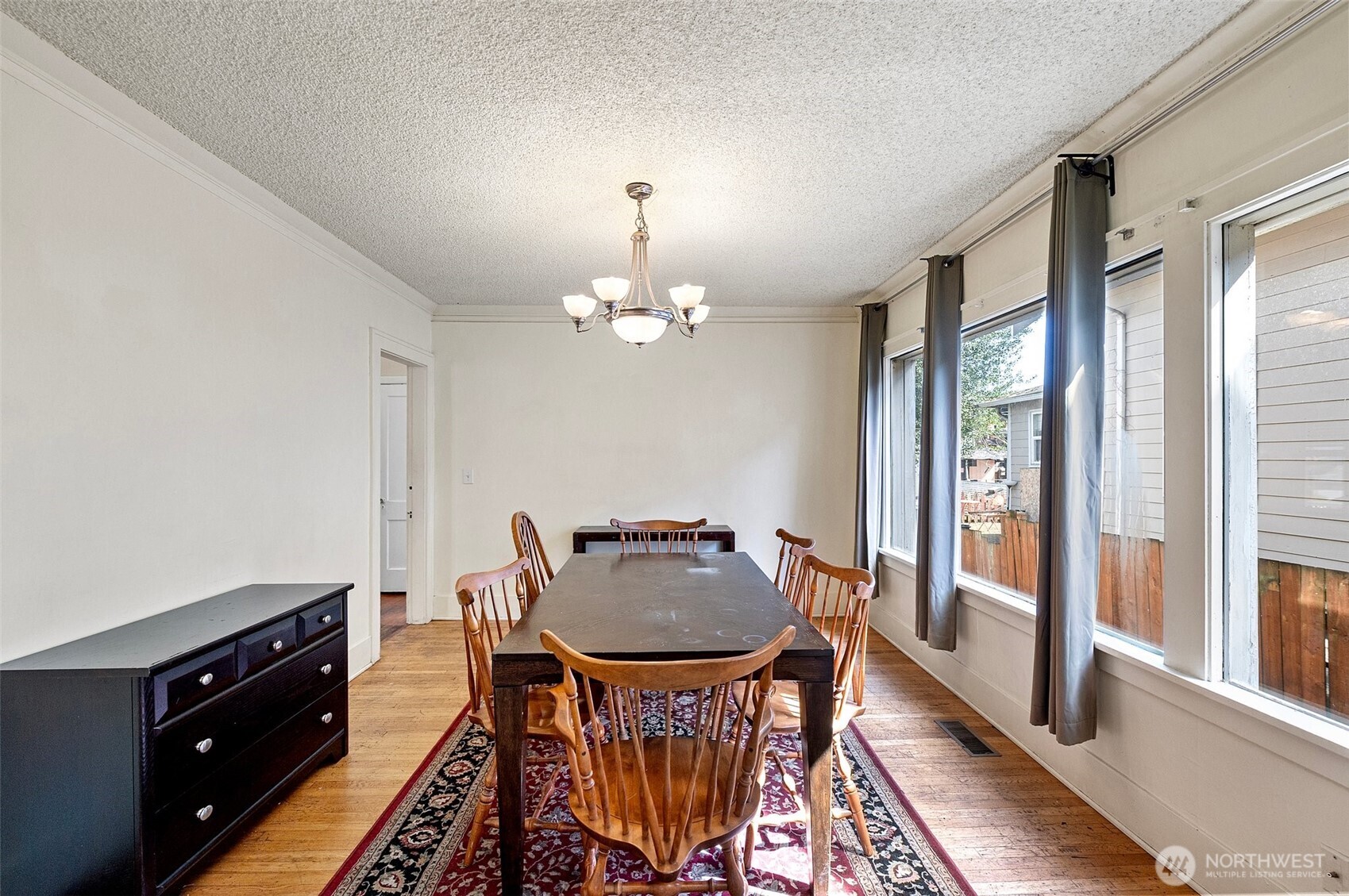 5016 7th Avenue Northeast Seattle, WA 98105 - Photo 9 of 36 a view of a dining room with furniture window and wooden floor