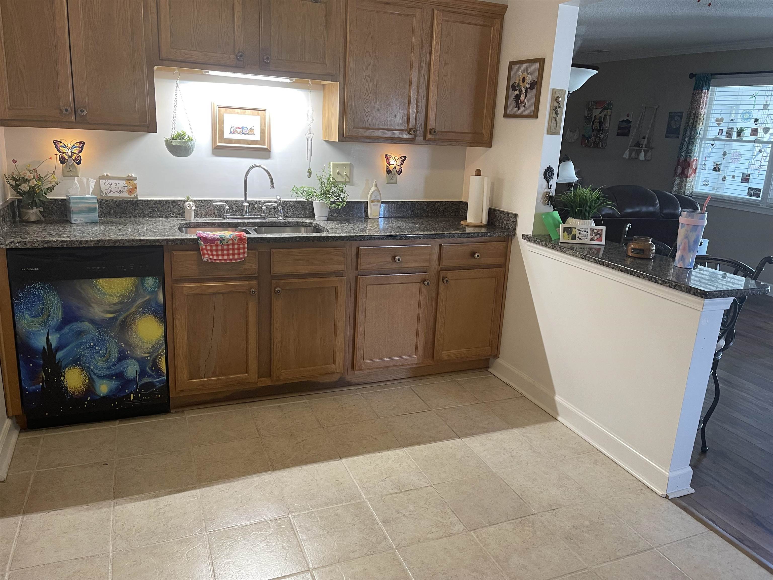 2346 Imogene Street Memphis, TN 38114 - Photo 3 of 16 a kitchen with stainless steel appliances granite countertop a sink a stove a microwave a counter top and cabinets