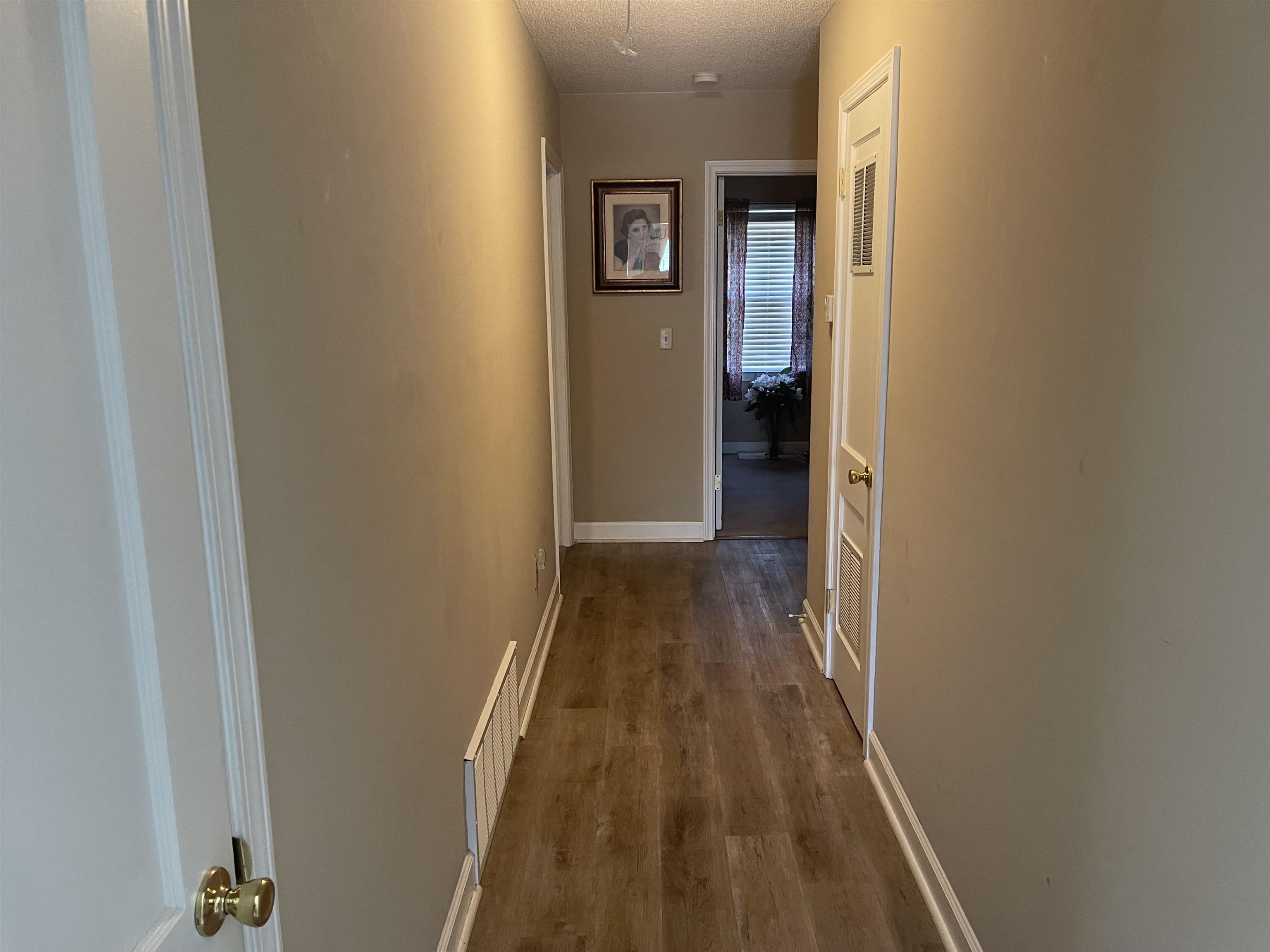 2346 Imogene Street Memphis, TN 38114 - Photo 8 of 16 a view of a hallway with wooden floor and a bathroom