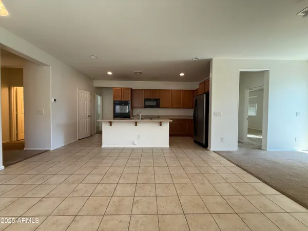 a view of a kitchen with a sink and white cabinets