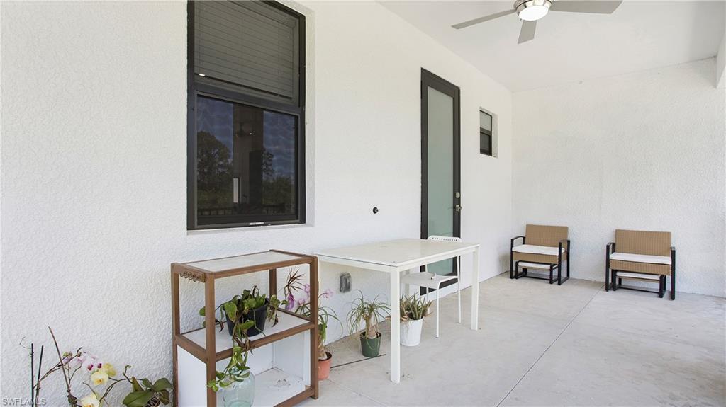 2343 Oil Well Road Naples, FL 34120 - Photo 33 of 46 Outdoor patio space featuring a contemporary ceiling fan with integrated lighting, durable concrete flooring, and a dark-framed glass door