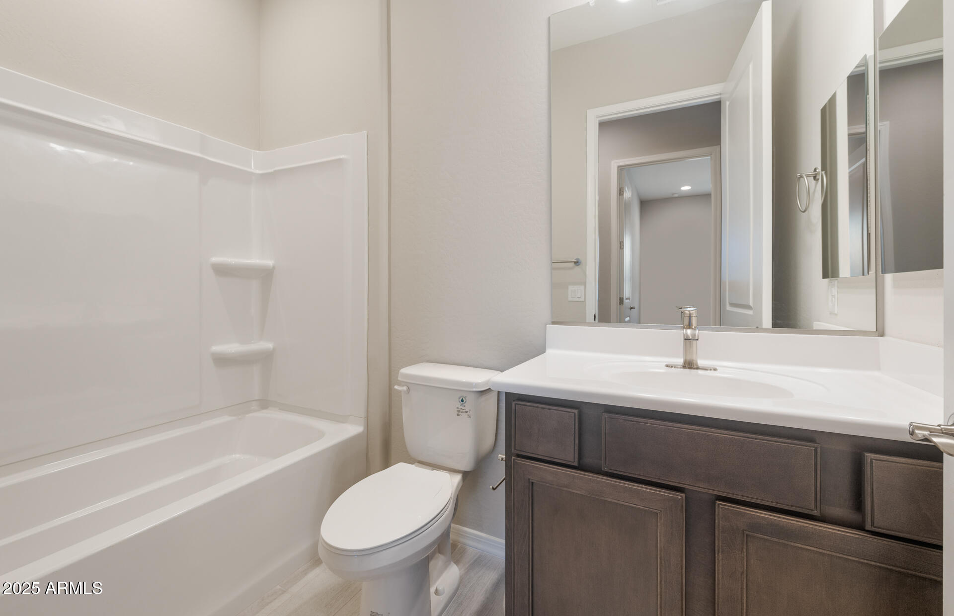 7802 West Mockingbird Way Florence, AZ 85132 - Photo 14 of 34 a bathroom with a bathtub shower sink vanity mirror and toilet