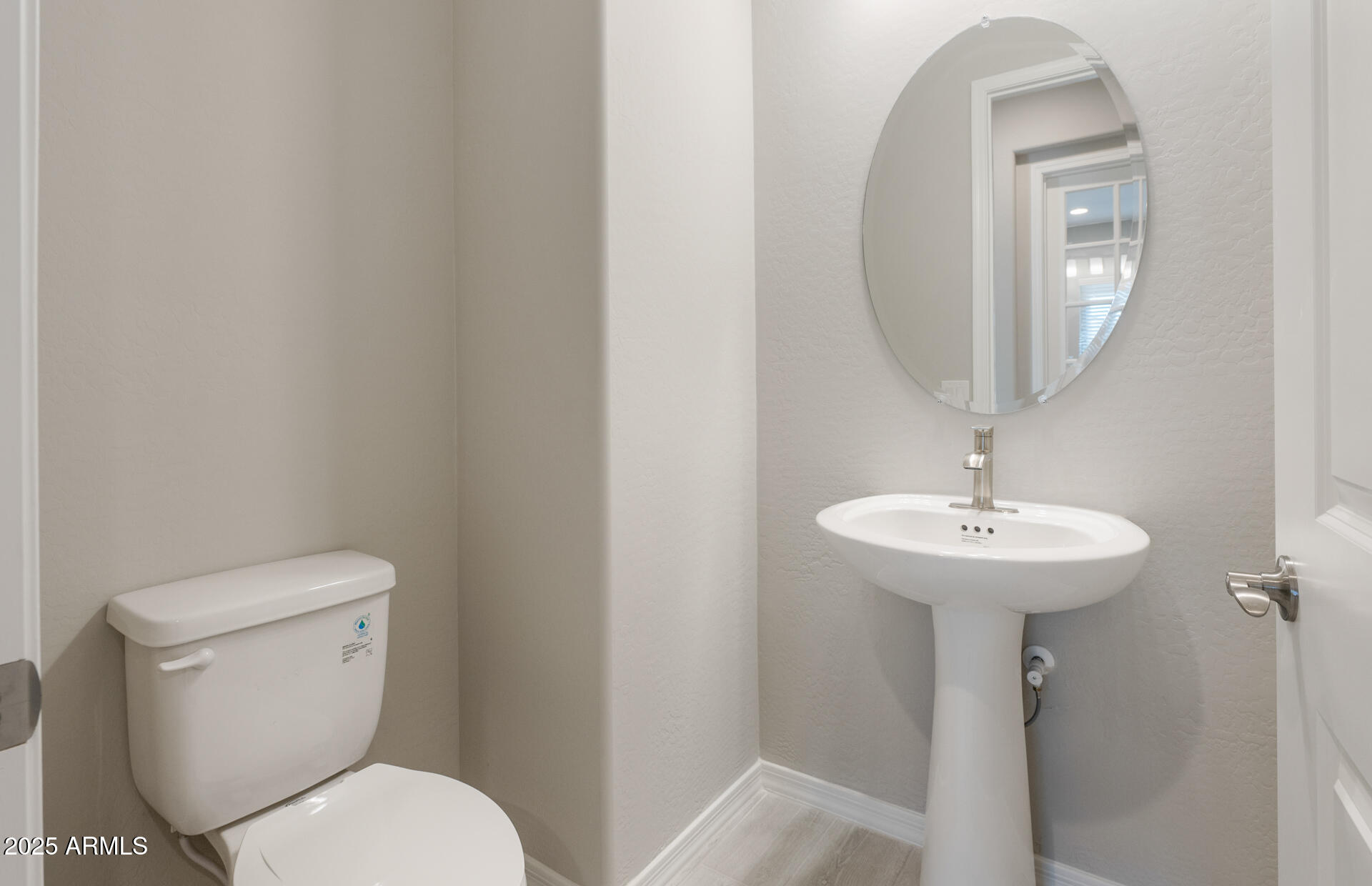 7802 West Mockingbird Way Florence, AZ 85132 - Photo 15 of 34 a bathroom with a toilet a sink and mirror
