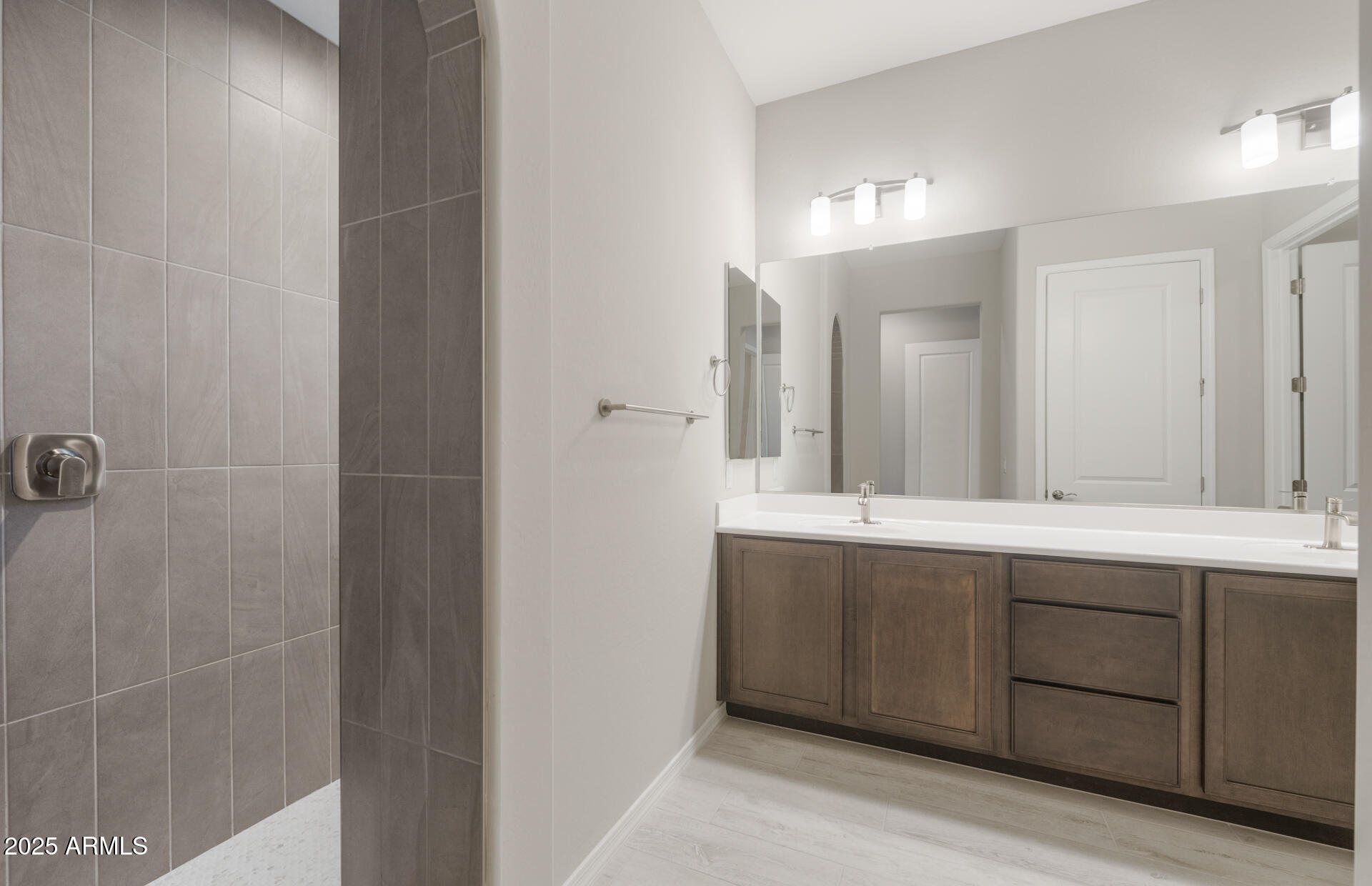 7802 West Mockingbird Way Florence, AZ 85132 - Photo 19 of 34 a bathroom with a double vanity sink and mirror