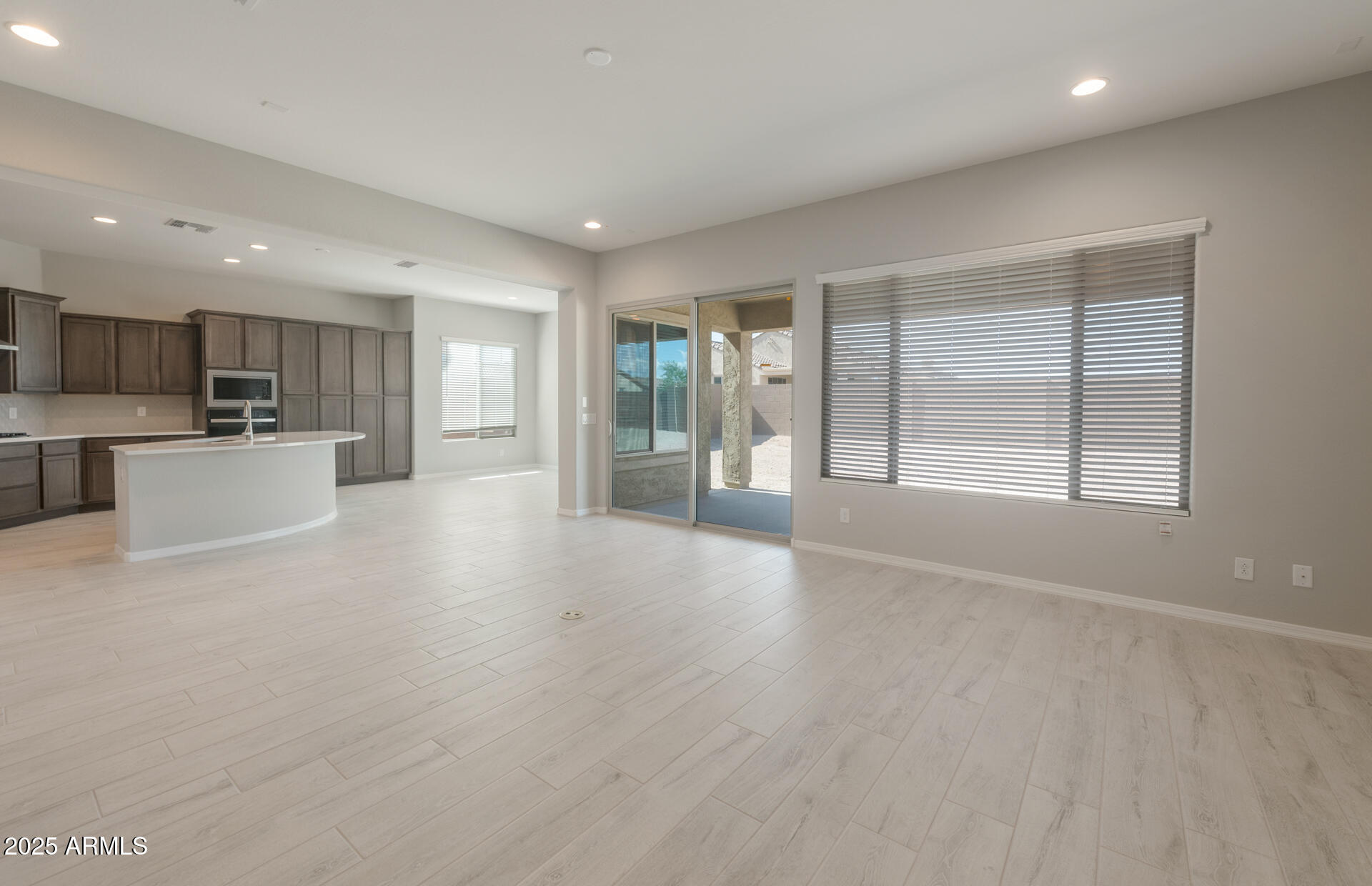 7802 West Mockingbird Way Florence, AZ 85132 - Photo 4 of 34 a view of a kitchen with a sink and dishwasher a refrigerator with wooden floor