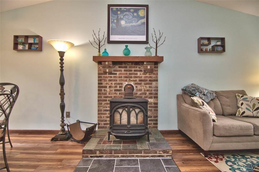 4280 Pne Rdg Drive Bushkill, PA 18324 - Photo 6 of 32 a living room with furniture a fireplace and a table