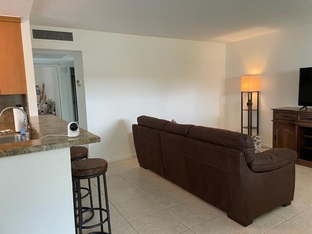 348 Monaco H Delray Beach, Unit 348 Delray Beach, FL 33446 - Photo 7 of 41 a living room with furniture and a mirror