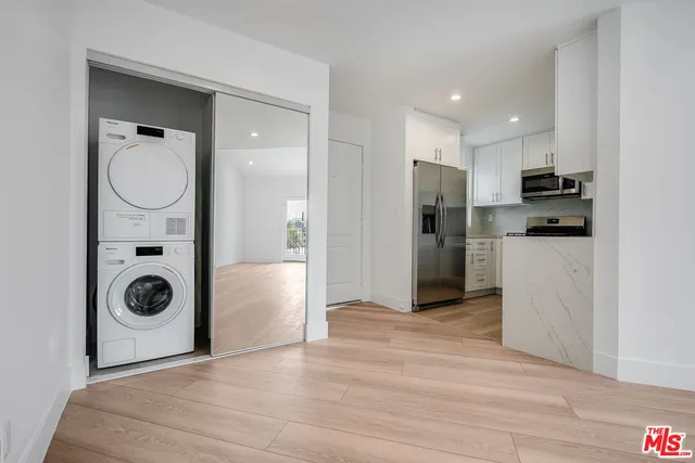 a view of a kitchen with a washer and dryer