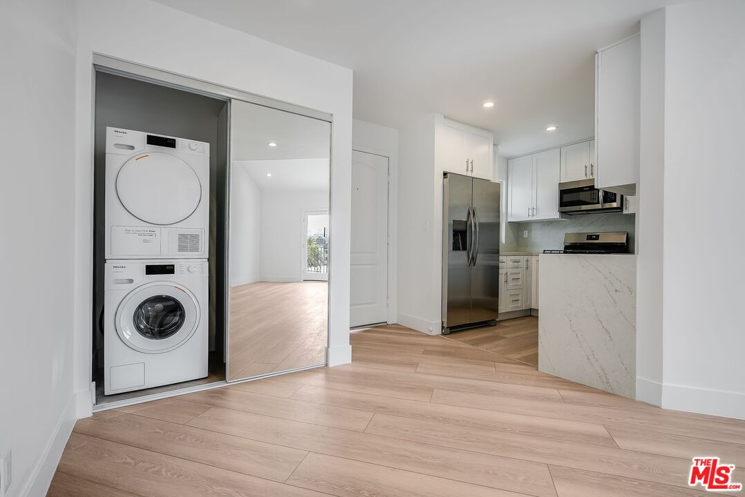 11675 Darlington Avenue, Unit 301 Los Angeles, CA 90049 - Photo 11 of 16 a view of a kitchen with a washer and dryer