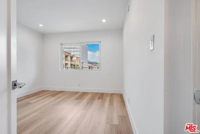 a view of room with window and hardwood floor
