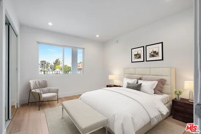 a bedroom with a bed and a couch