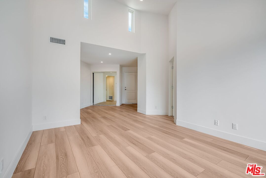 11675 Darlington Avenue, Unit 301 Los Angeles, CA 90049 - Photo 6 of 16 a view of an empty room and wooden floor
