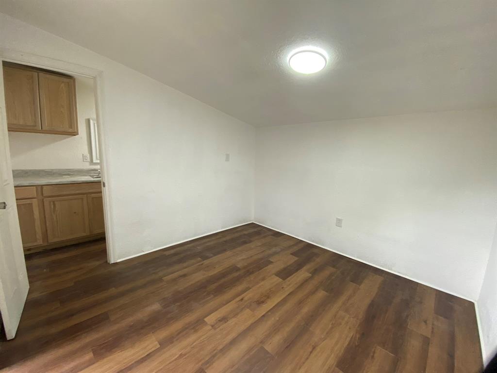 14131 Northwest 3rd Avenue, Unit E Miami, FL 33168 - Photo 4 of 7 a view of empty room with wooden floor