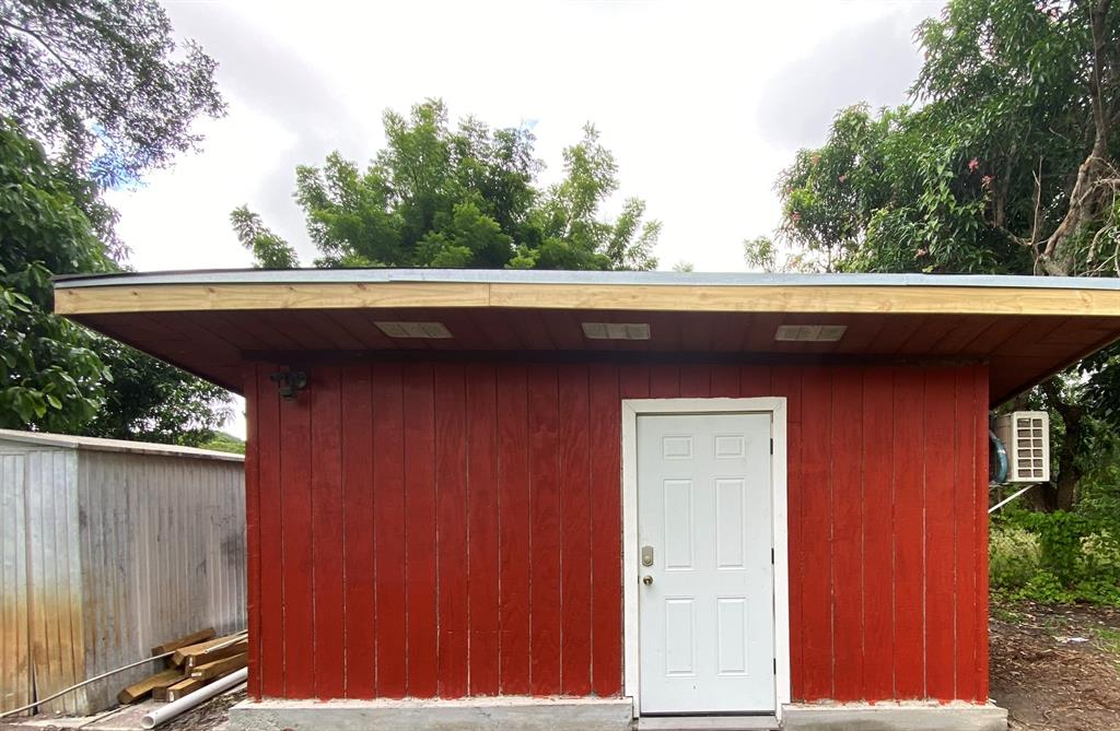 14131 Northwest 3rd Avenue, Unit E Miami, FL 33168 - Photo 5 of 7 a side view of a house with a door