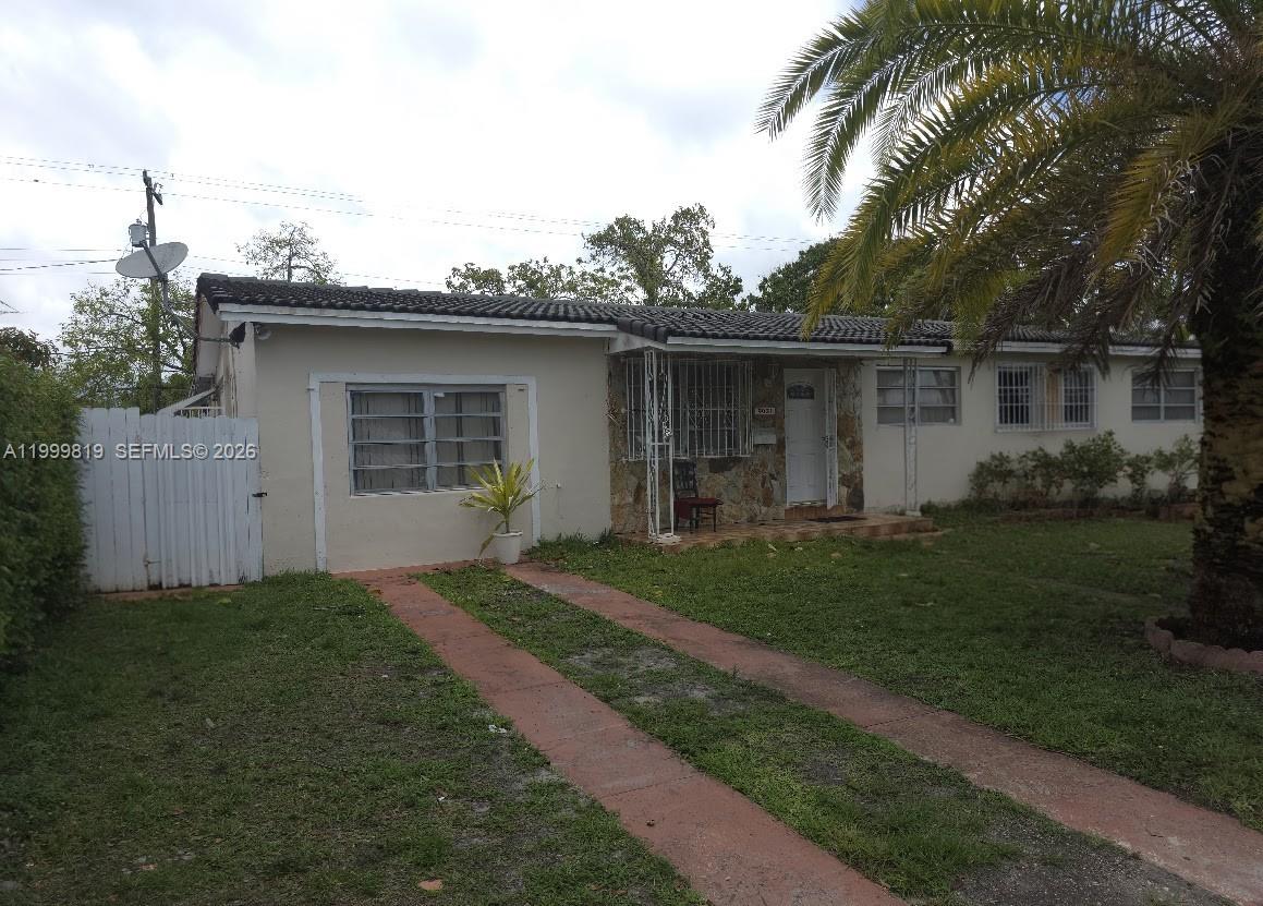 9021 Southwest 30th Terrace Miami, FL 33165 - Photo 1 of 18 a front view of a house with a garden