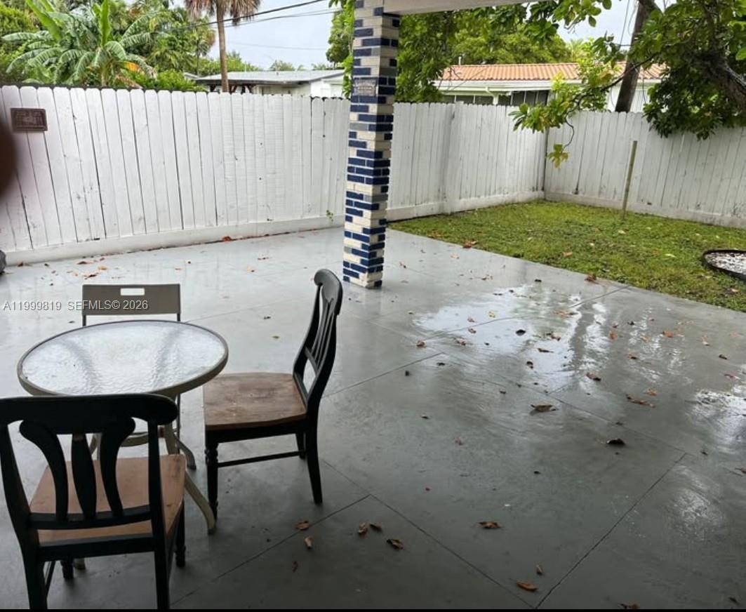 9021 Southwest 30th Terrace Miami, FL 33165 - Photo 12 of 18 a backyard of a house with table and chairs