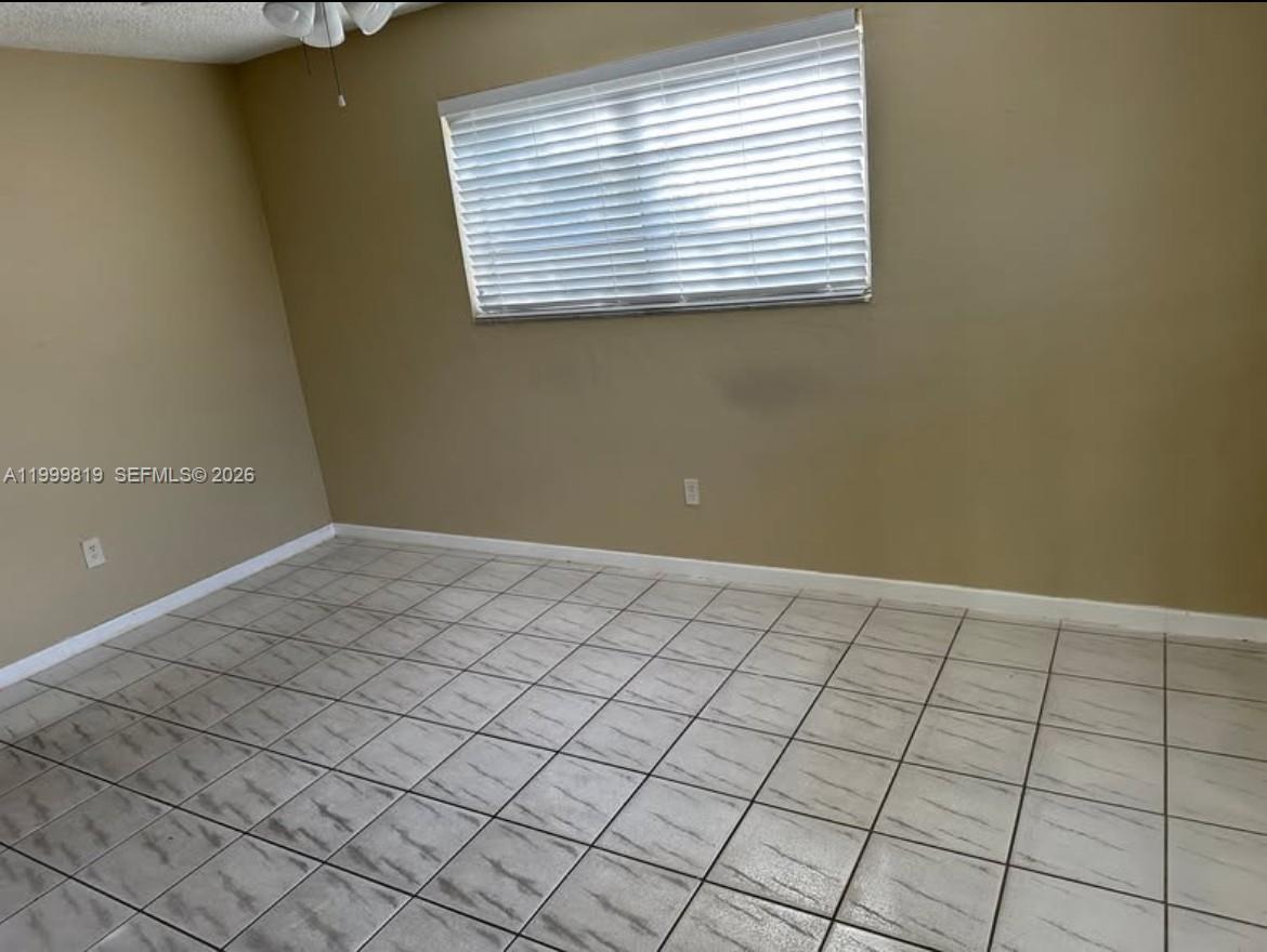 9021 Southwest 30th Terrace Miami, FL 33165 - Photo 15 of 18 a view of an empty room and window