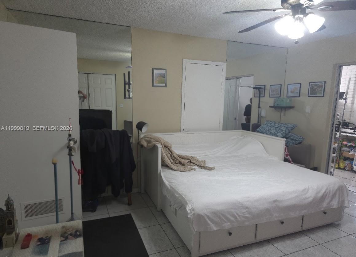 9021 Southwest 30th Terrace Miami, FL 33165 - Photo 17 of 18 a bedroom with a bed and a chandelier