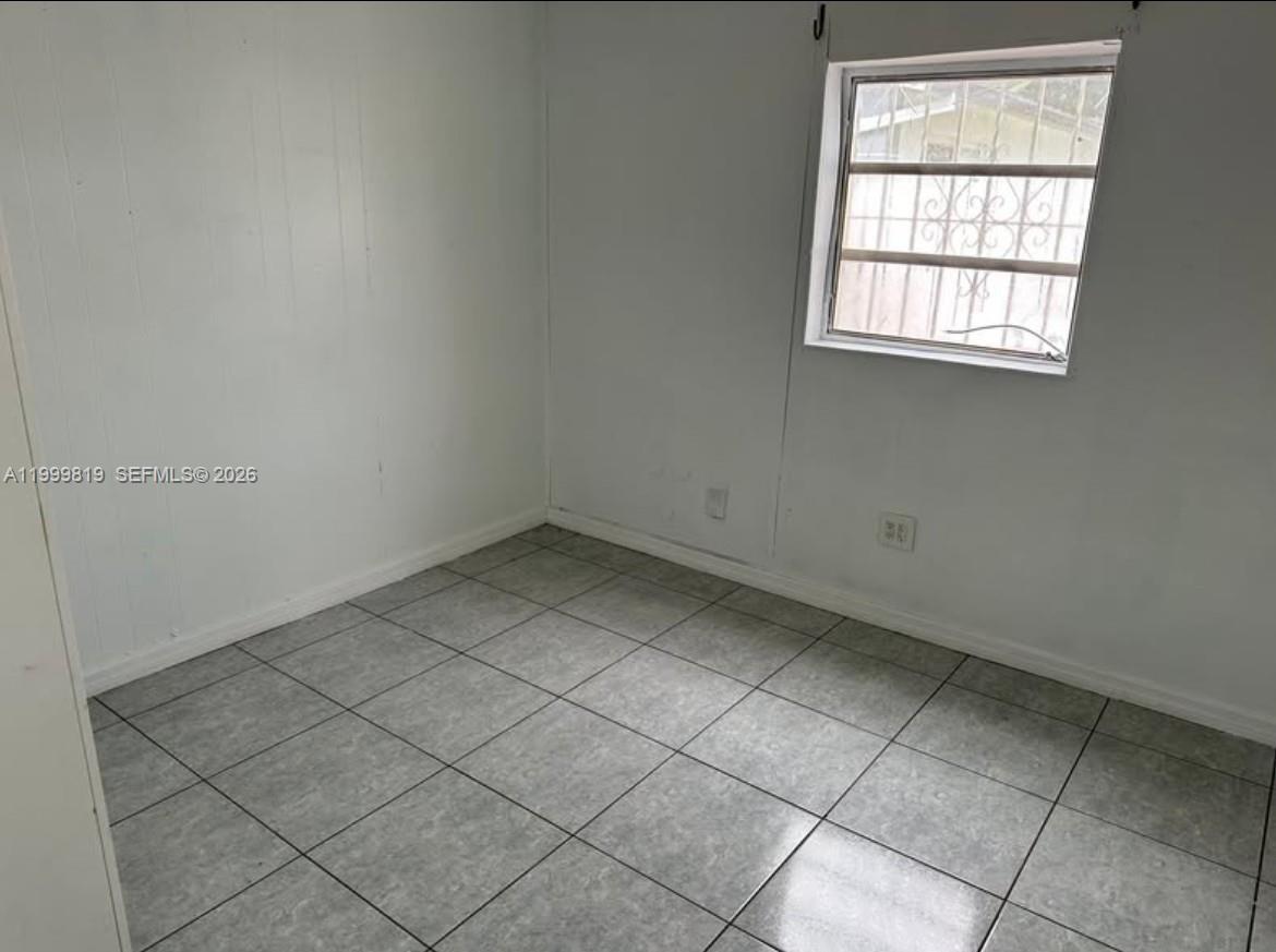 9021 Southwest 30th Terrace Miami, FL 33165 - Photo 8 of 18 an empty room with a window