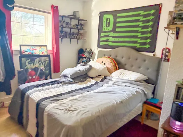 a bedroom with a bed and a window