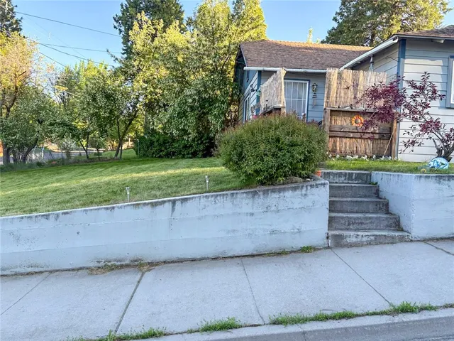 a front view of a house with a yard and a garage