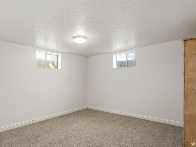 15680 North Beaver Dam Road Collinston, UT 84306 - Photo 33 of 49 Room featuring two high-set windows, recessed baseboards, and neutral carpeting
