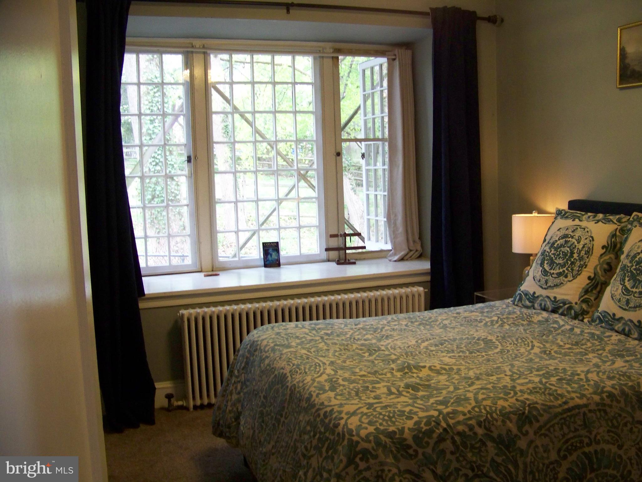 335 Bent Road Wyncote, PA 19095 - Photo 16 of 45 a bed sitting in a bedroom next to a window
