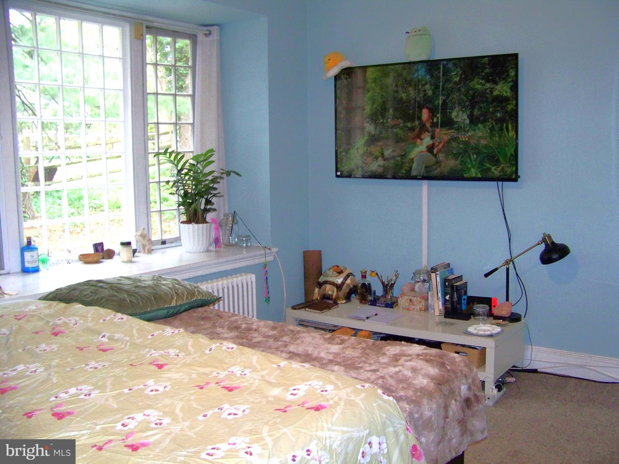 335 Bent Road Wyncote, PA 19095 - Photo 17 of 45 a bedroom with a bed and a painting on the wall