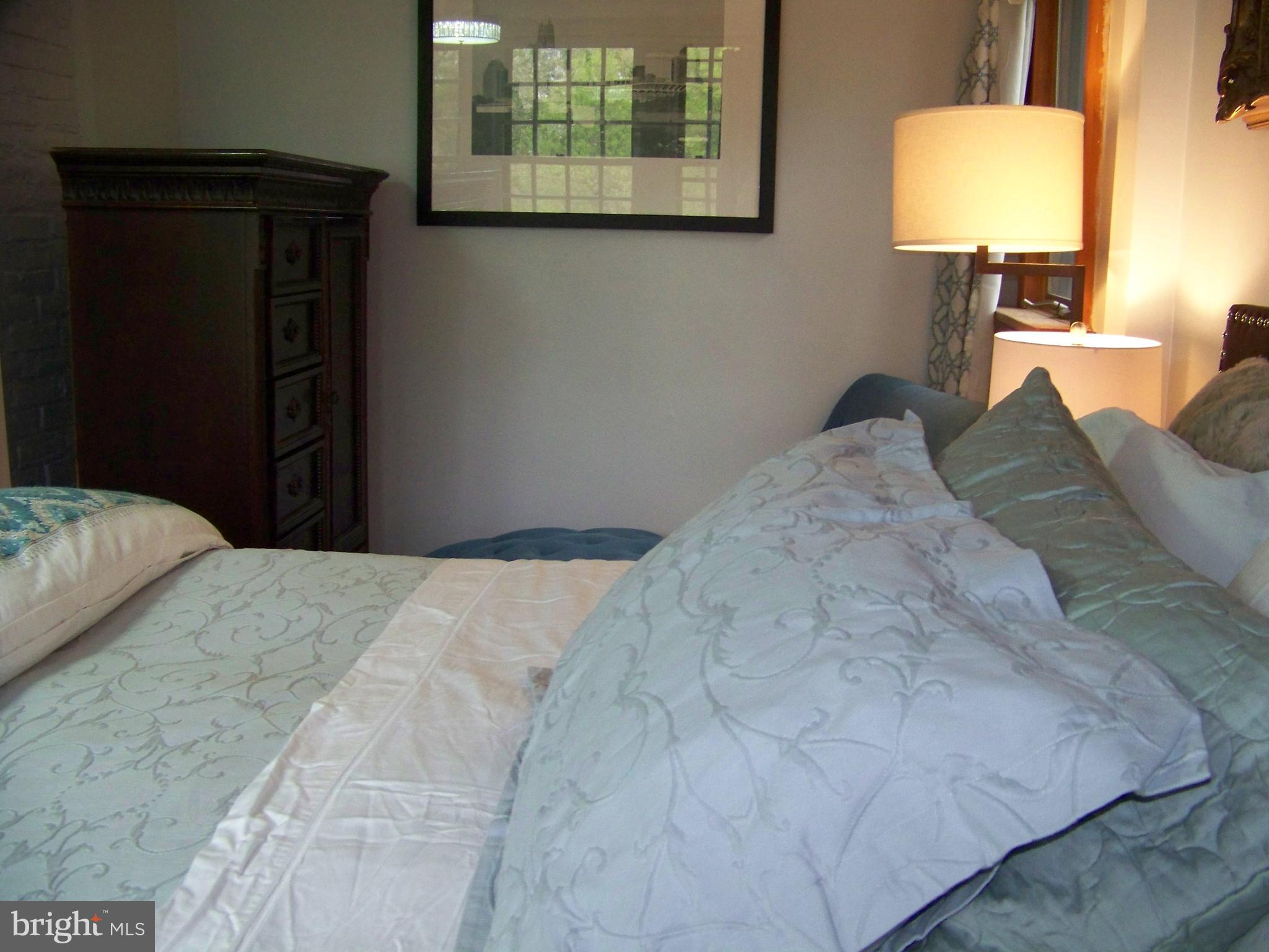 335 Bent Road Wyncote, PA 19095 - Photo 42 of 45 a bedroom with a bed and a lamp on table