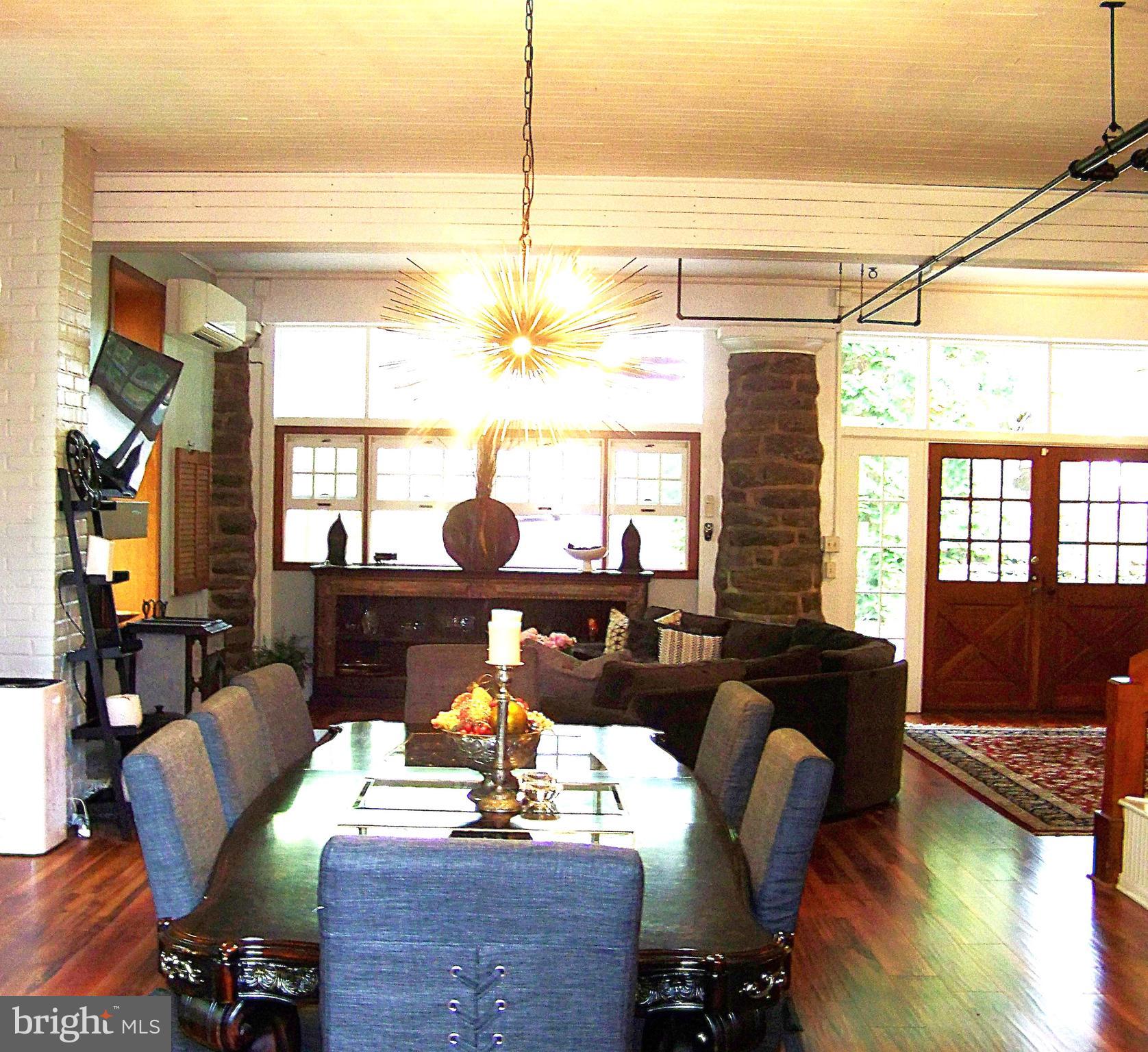 335 Bent Road Wyncote, PA 19095 - Photo 6 of 45 a living room with couches bookshelf and a large window with wooden floor
