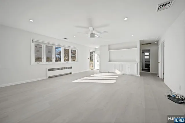 a view of livingroom with hardwood floor and ceiling fan
