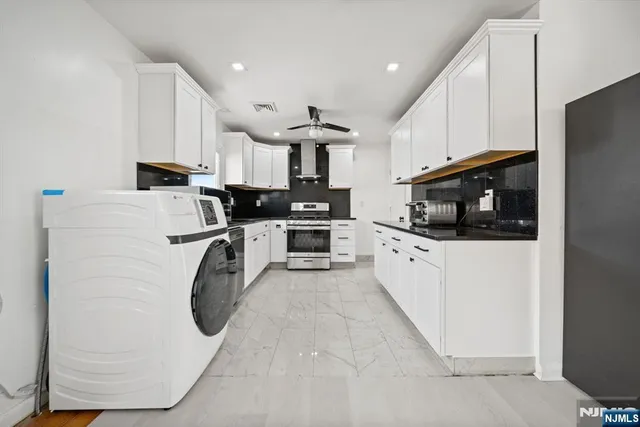 a kitchen with white cabinets and white appliances