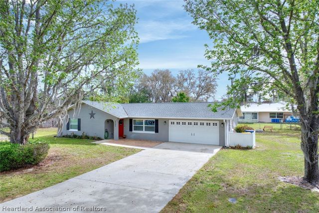 a view of a house with a yard and tree s