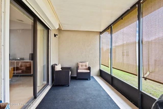 a bedroom with furniture and a large window