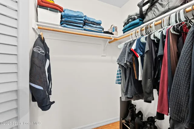 a bathroom with a sink a toilet a mirror and shower