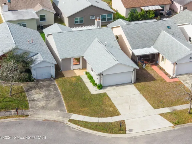 an aerial view of residential houses with outdoor space