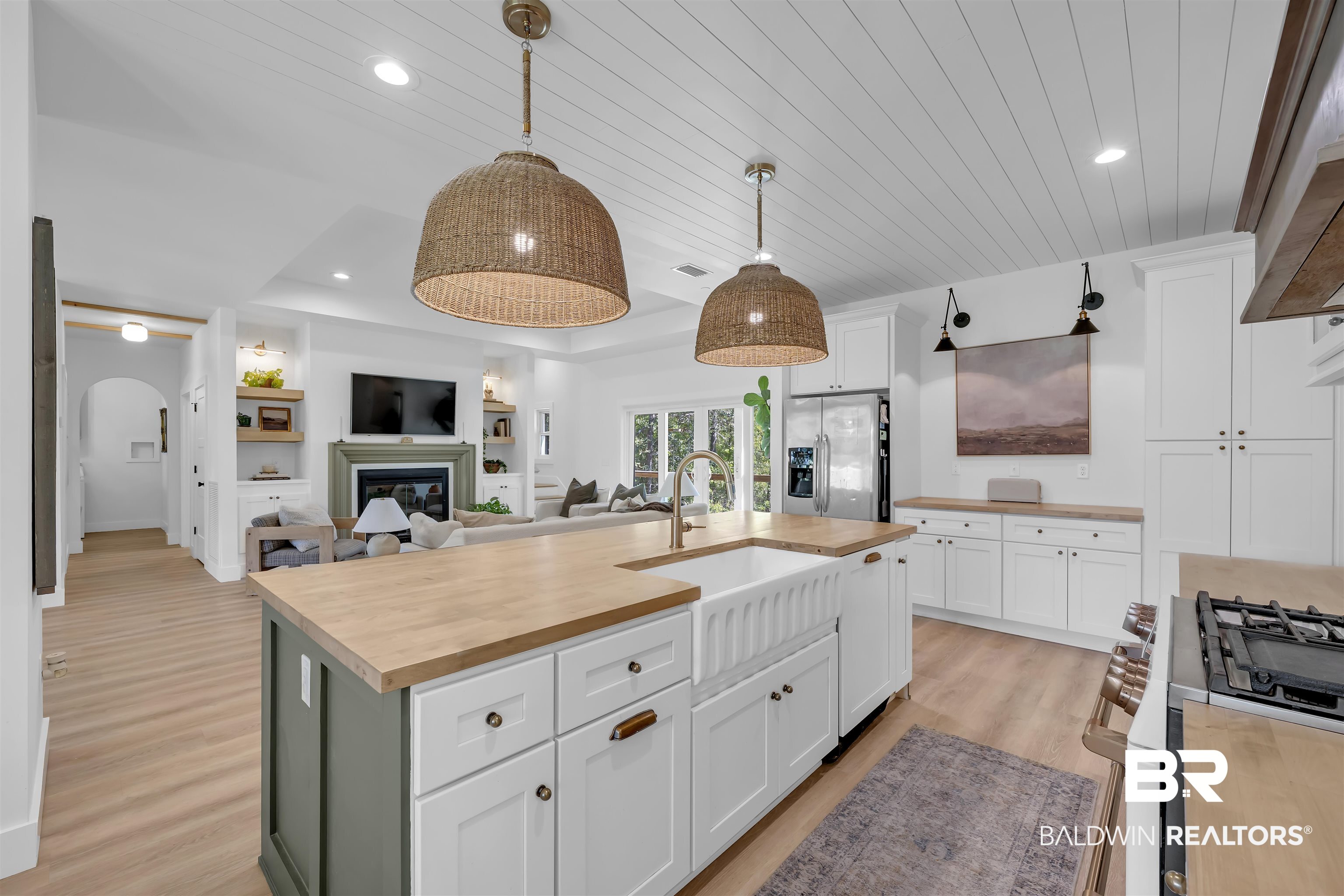 19058 James Road Gulf Shores, AL 36542 - Photo 48 of 49 Kitchen with wooden counters, open floor plan, stainless steel appliances, a center island with sink, and white cabinetry