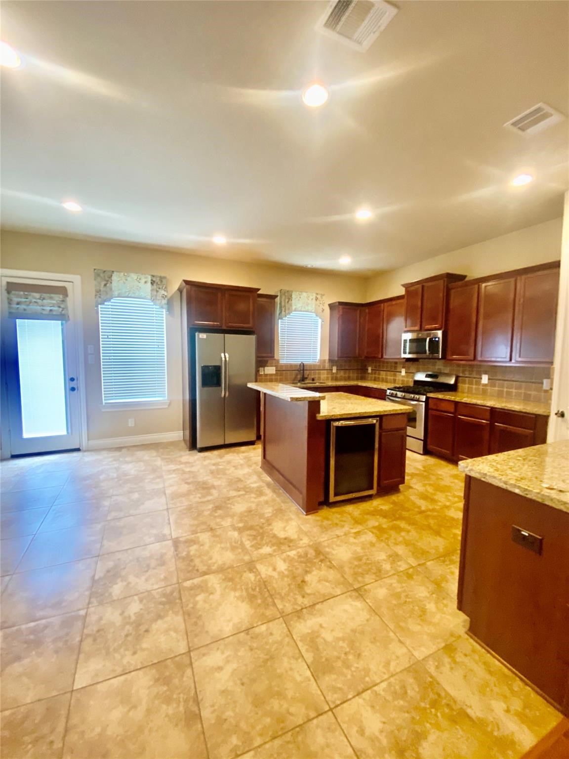 1306 Dian Street Houston, TX 77008 - Photo 4 of 17 a large kitchen with stainless steel appliances granite countertop a stove and cabinets