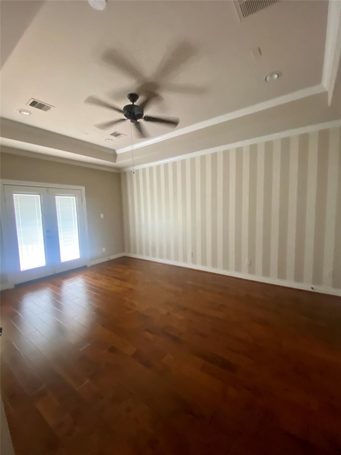 1306 Dian Street Houston, TX 77008 - Photo 5 of 17 an empty room with wooden floor fan and windows