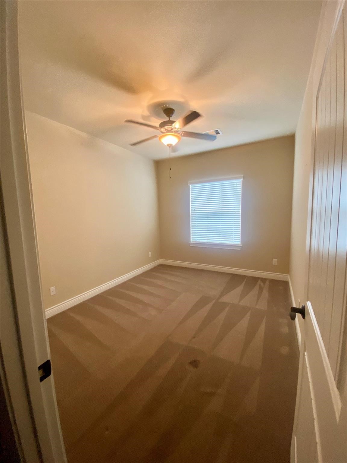 1306 Dian Street Houston, TX 77008 - Photo 8 of 17 an empty room with windows and fan