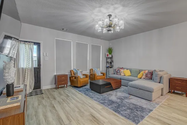 a bedroom with a bed and a chandelier