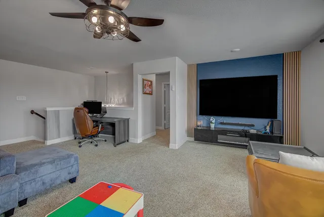 a bedroom with a bed and a lamp on dresser